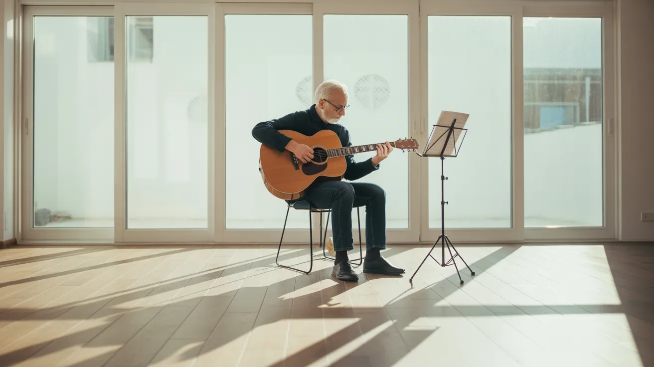 An older man sits on a stool playing guitar in a living room brightly lit by harsh sun from a window, with a music stand nearby.